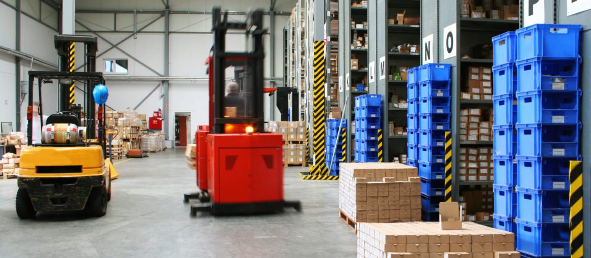 Busy warehouse with pallet trucks working